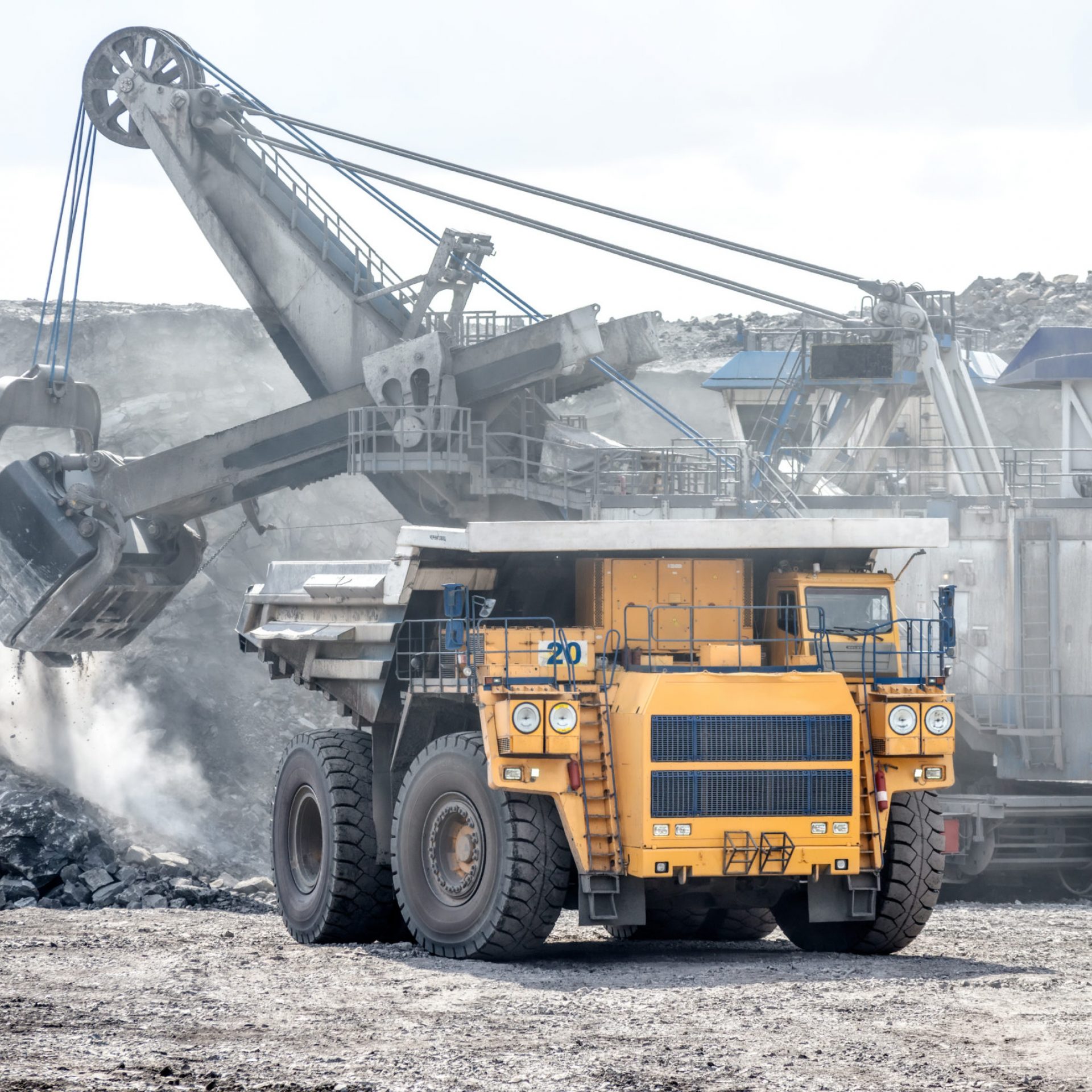 Ore loading with a powerful excavator. Loading a large mining truck. Mining operations in the face of a quarry.
